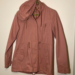 Pink trench coat, slight damage around right hand pocket, adjustable waist